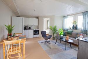 a kitchen and living room with a couch and a table at Yess-Vadsø in Vadsø