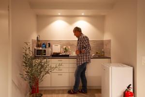 a man standing in the kitchen of a kitchen at Yess-Vadsø in Vadsø
