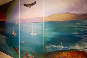 a painting of the ocean with boats in the water at Yess-Vadsø in Vadsø