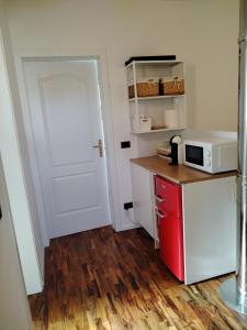 a kitchen with a white door and a microwave at Alle Nuove Stelle in Udine