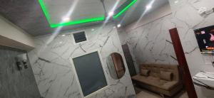 a bathroom with a mirror and a couch on a wall at Hotel Siddhant in Pithorāgarh +34 photos