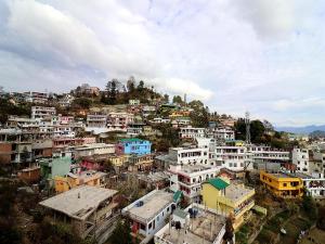 a group of buildings on top of a hill at Hotel Siddhant in Pithorāgarh