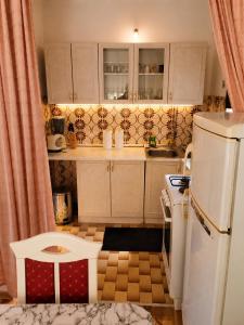 a small kitchen with a sink and a toilet at Aura Apartment Sarajevo in Sarajevo +8 photos