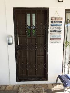 a door to a house with a sign on it at Eluthando Guesthouse in St Lucia