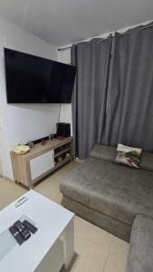a living room with a couch and a flat screen tv at Mediterraneo in Peniscola