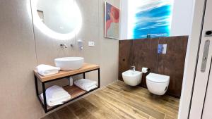 a bathroom with a sink and a toilet at Alloggio degli Eroi by LocazioniOK in Mola di Bari +23 photos