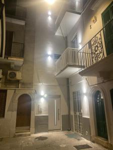 an empty hallway of a building with a staircase at Alloggio degli Eroi by LocazioniOK in Mola di Bari