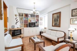 a living room with a couch and a tv at Palairos Historic Villa in Paleros