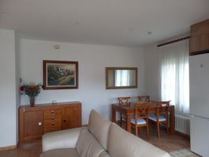 a living room with a couch and a table at Apartament Can Jaumató in Sant Quirze de Besora