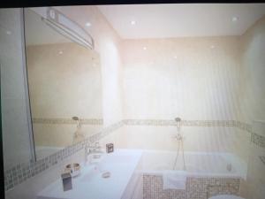 a bathroom with a tub and a sink and a mirror at Chic Villa Webb Cannes in Cannes