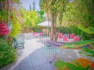 a hammock in a garden with chairs and trees at Chic Villa Webb Cannes in Cannes +5 photos