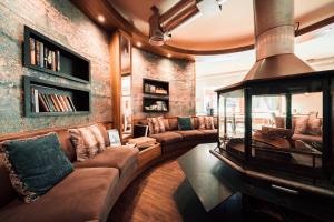 a living room with a couch and a fireplace at Hotel Bellerive in Zermatt