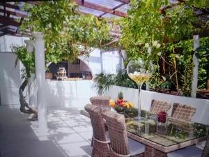 a patio with a glass table and chairs at Chic Villa Webb Cannes in Cannes