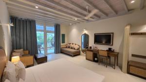a large living room with a couch and a television at Nilaveli Beach Hotel in Nilaveli
