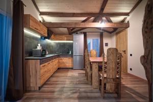 a kitchen with a table and a refrigerator at Family Plai in Yaremche
