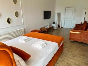 a hotel room with a bed and a couch at Ami Residence Bucharest Airport,Therme&FREE PARKING Otopeni in Otopeni
