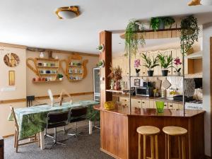 a kitchen with a table and some plants on the wall at AGROTURYSTYKA POD ŚNIEŻNĄ in Bystrzyca Kłodzka