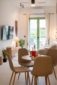 a living room with a table and chairs at Asini deluxe suite 3, with rooftop terrace and breathtaking views in Asíni