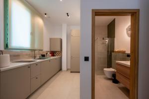 a bathroom with a sink and a toilet in it at Asini deluxe suite 3, with rooftop terrace and breathtaking views in Asíni +45 photos