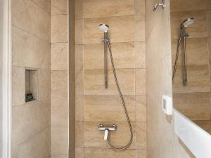 a bathroom with a shower with a shower head at Hôtel le calife in Tunis +50 photos
