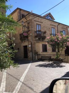 an old brick building with balconies on a street at Bed and Breakfast Family Palazzo Stillitano Stilo in Stilo