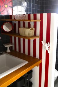a bathroom with a red and white striped wall at Stripe Studio in Bonne-sur-Ménoge +15 photos