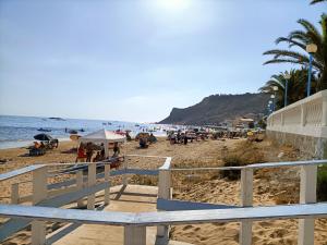 a beach with a bunch of people and the ocean at Affitto breve Puccio A Chiazza Realmonte in Realmonte