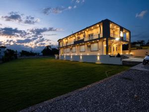 a large building with lights on the side of a field at Glotus Hotel in Herbertpur