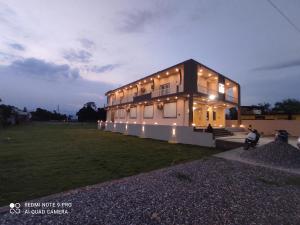 a large house with lights on the side of it at Glotus Hotel in Herbertpur
