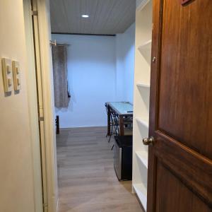 a hallway with a room with a table and a door at Sunflower Residences Capitol formerly mayflower inn in Cebu City