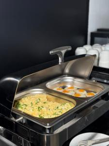 a pan filled with food in an oven at Aqua Hotel in Solotvyno +57 photos