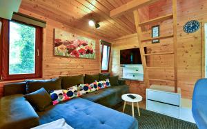 a living room with a blue couch in a cabin at Tiny House Grabovac in Rakovica