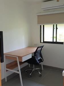 an office with a desk with a chair and a window at Good Mood Bungalows in Ko Phangan