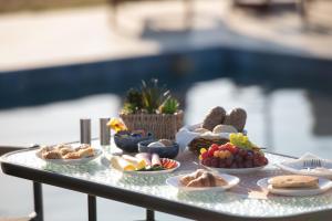 a table topped with plates of food on a table at Mini Boutique Dragani in Sykia Chalkidikis