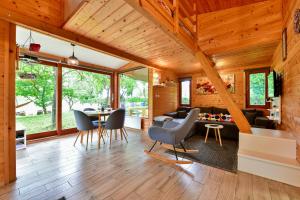 a large living room with a table and chairs at Tiny House Grabovac in Rakovica