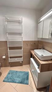 a bathroom with a sink and a toilet and a mirror at Kunst küsst Küste in Hohwacht +23 photos