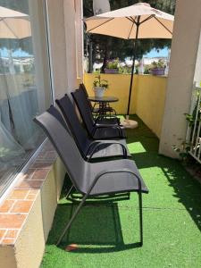 a group of chairs and an umbrella on a patio at Центр солнечного берега in Sunny Beach