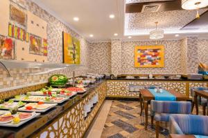 a restaurant with plates of food on a buffet at Trend Park Hotel in Antalya