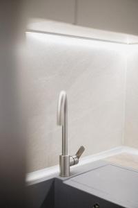 a sink with a faucet in a bathroom at No7 Pool House in Iraklitsa