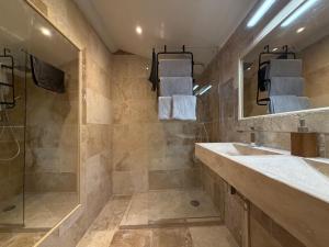 a bathroom with a shower and a sink and a mirror at Bastide Hedone en Luberon in Apt +43 photos