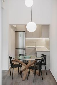 a dining room with a table and chairs in a kitchen at No7 Pool House in Iraklitsa