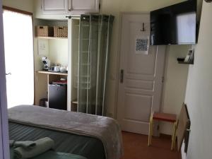 a room with a bed and a door and a door at La Pierrerie Bambou in Tourtour +8 photos