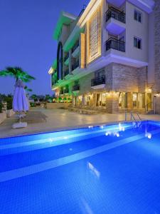 a hotel with a swimming pool in front of a building at Trend Park Hotel in Antalya
