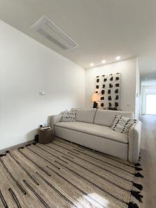a living room with a couch and a rug at Cidral Path 32 in Póvoa de Varzim