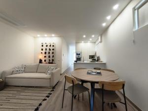 a living room with a table and a couch at Cidral Path 32 in Póvoa de Varzim