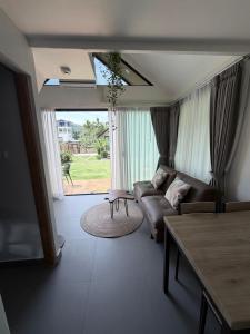 a living room with a couch and a table at Good Mood Bungalows in Ko Phangan