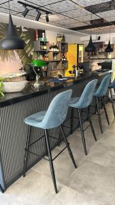 a bar with four chairs in front of a counter at Vega Suites in Antalya