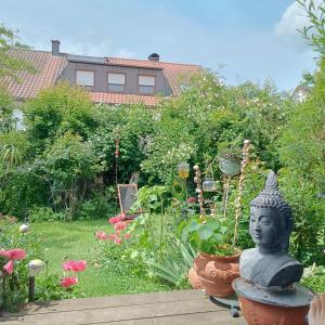 a statue in the middle of a garden at Ferienwohnung Röder am Schwimmteich in Bischofsheim an der Rhön
