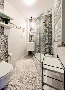 a bathroom with a shower and a toilet and a sink at PATIO dom gościnny in Łukęcin +45 photos