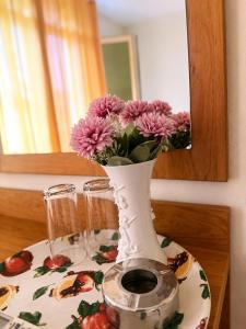 a vase filled with pink flowers on a table at Hotel Palace in Kranevo